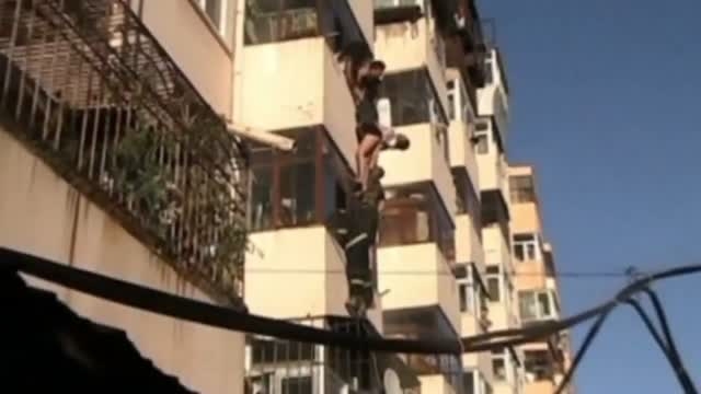 Couple rescued as they fall from balcony window